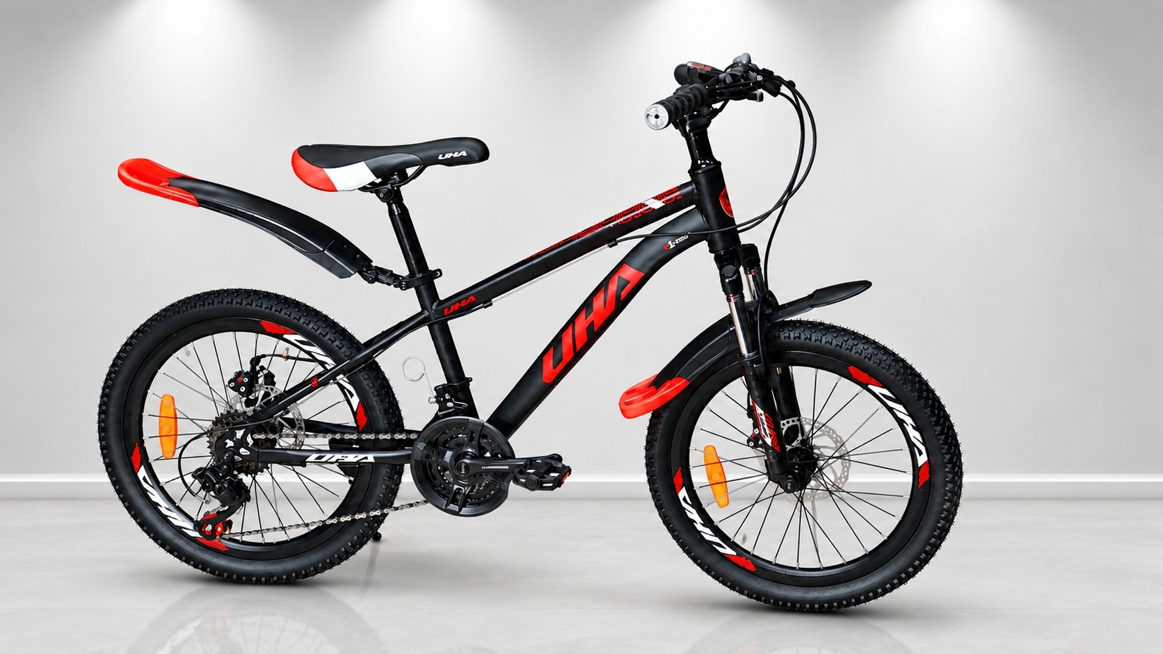Size 20 UHA mountain bike with a black and red frame, front suspension fork, 21-speed gearing, disc brakes, all-terrain tires, and mudguards, designed for young
