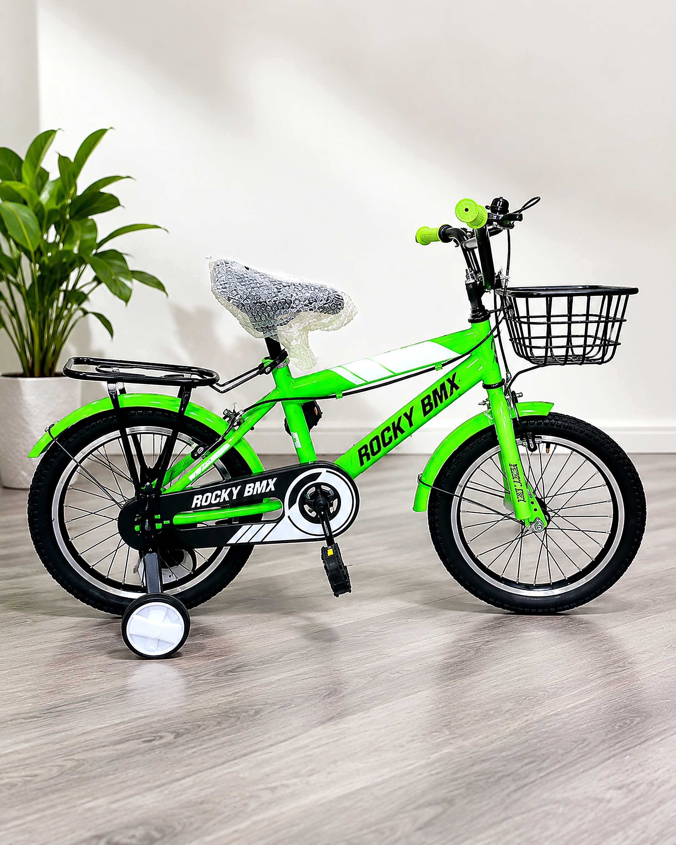 Rocky BMX 16-inch kids bicycle in bright green with training wheels, front basket, rear carrier, chain guard, and mudguards for children.