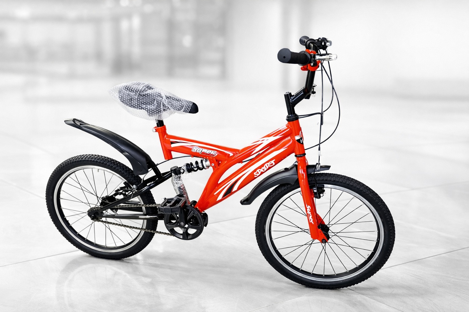 Side view of a Supersport 20-inch kids bicycle featuring a rear shock suspension, mudguards, durable tires, and sporty graphics.