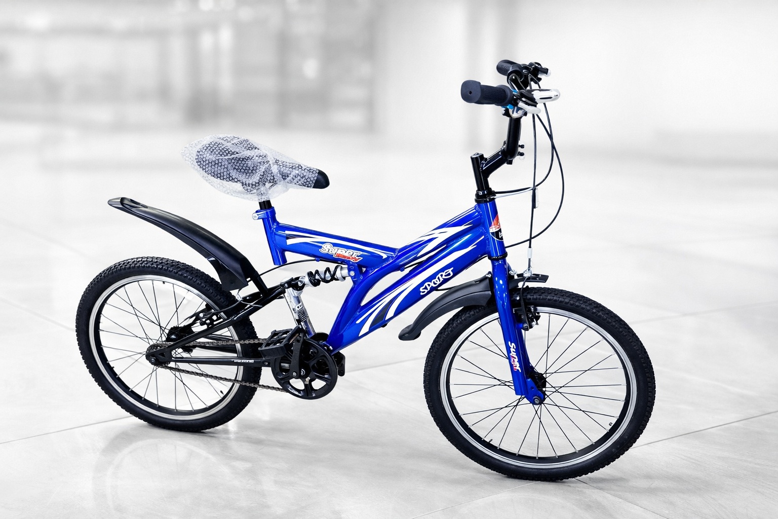 Side view of a Supersport 20-inch kids bicycle featuring a rear shock suspension, mudguards, durable tires, and sporty graphics.