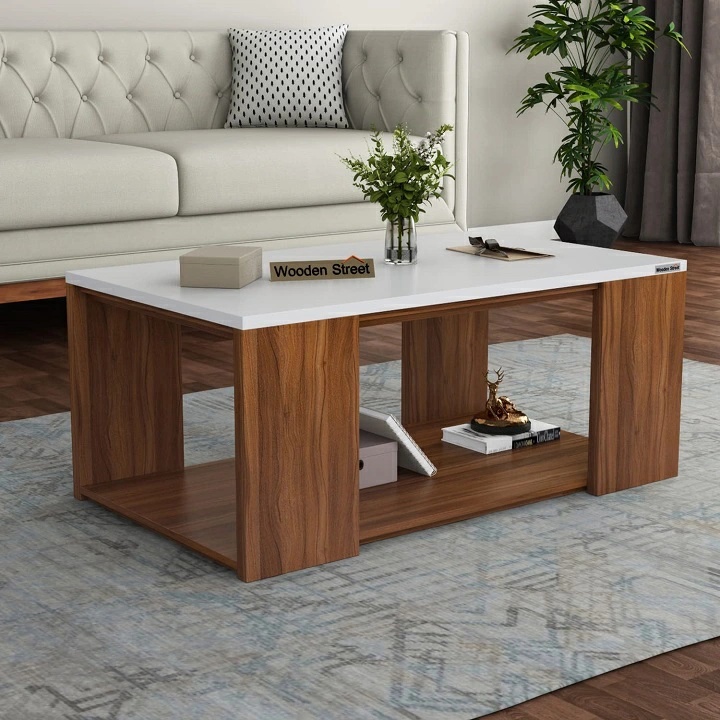 Modern white and oak coffee table featuring a spacious tabletop, sturdy wooden legs, and an open lower storage shelf for books, décor, and living room essential
