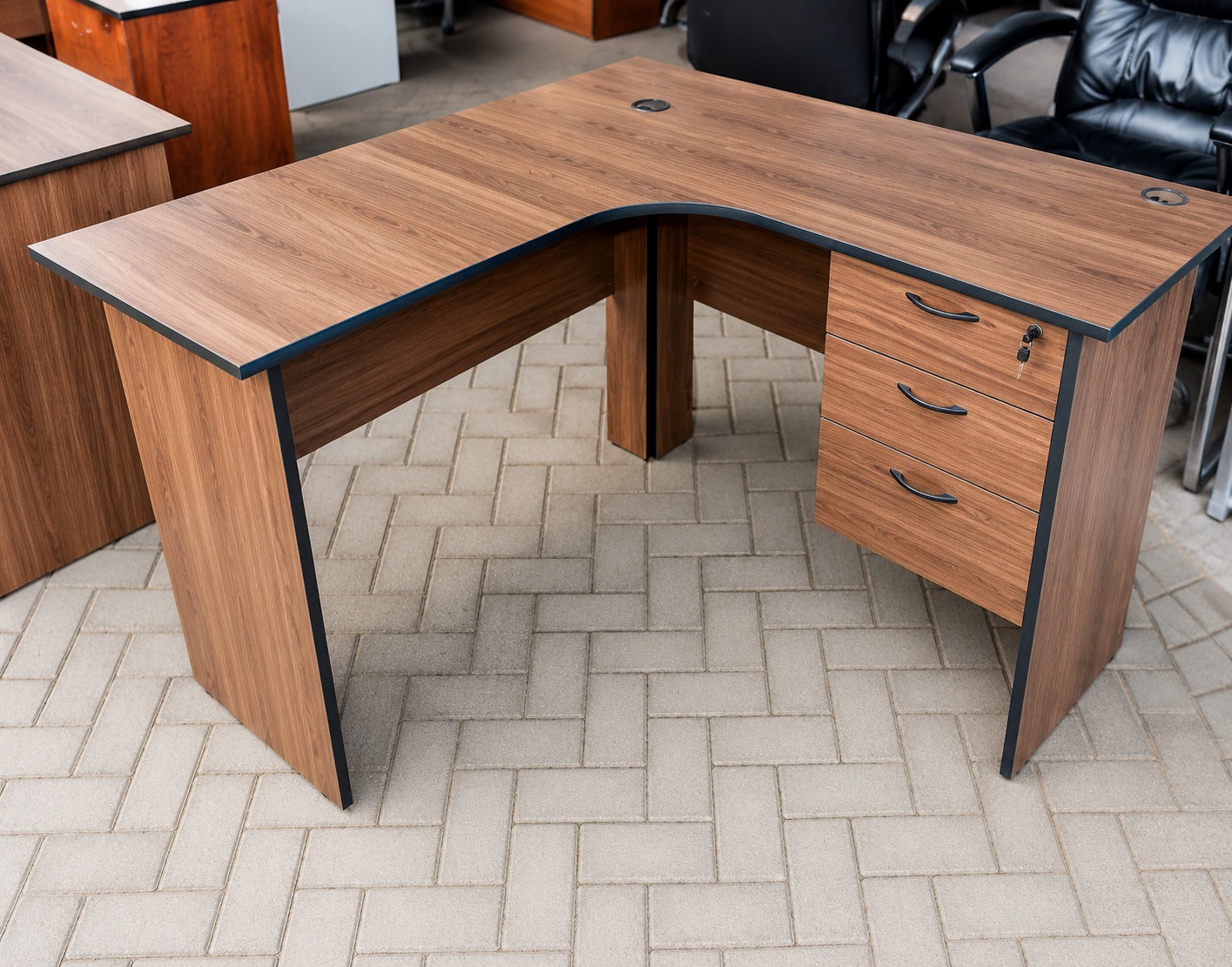 Executive L-shaped wooden office desk in walnut finish with lockable drawers, cable management ports, and spacious corner workstation.