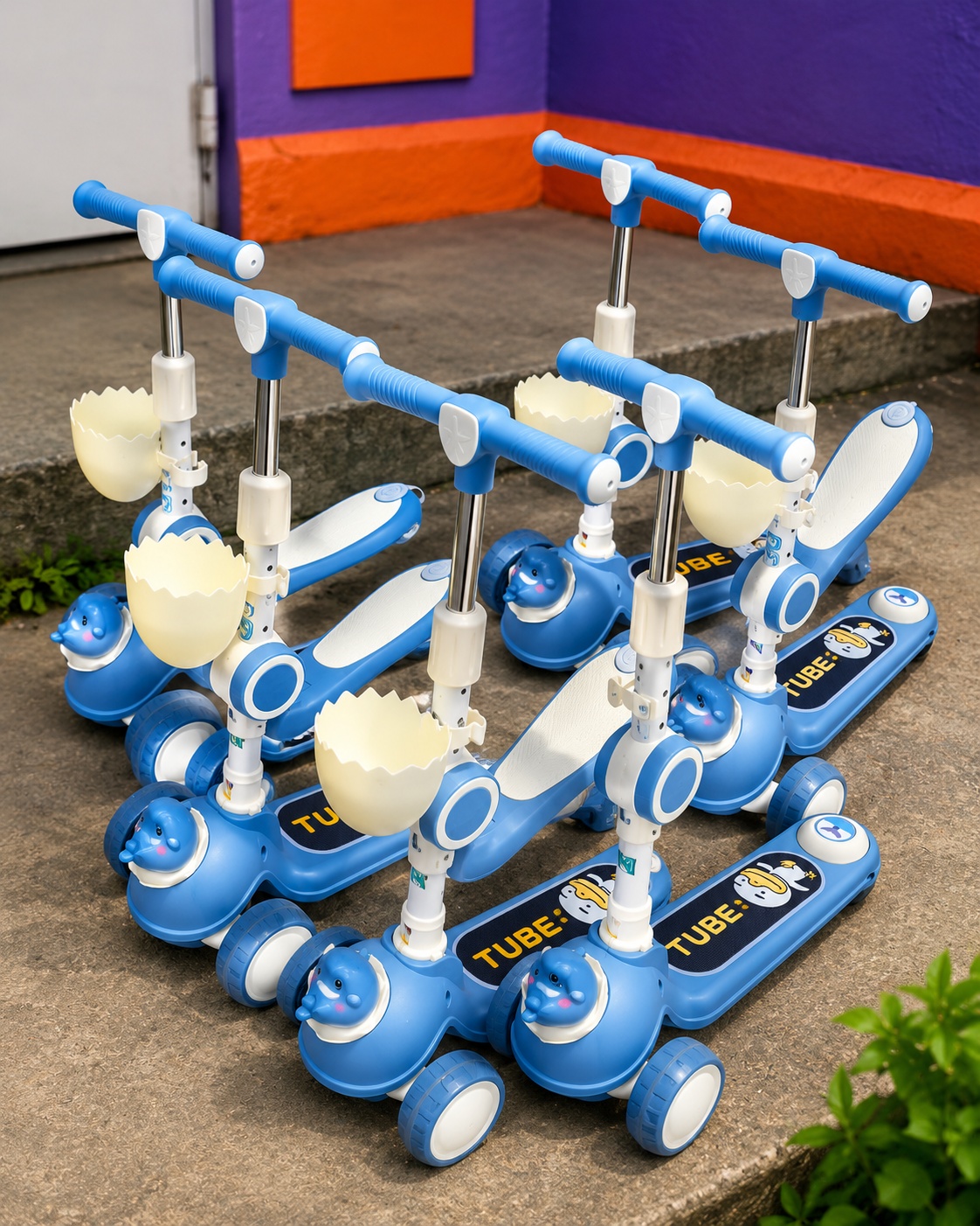 TUBE kids blue 3-wheel scooter featuring an adjustable handlebar, front storage basket, animal-themed design, and stable four-wheel support.