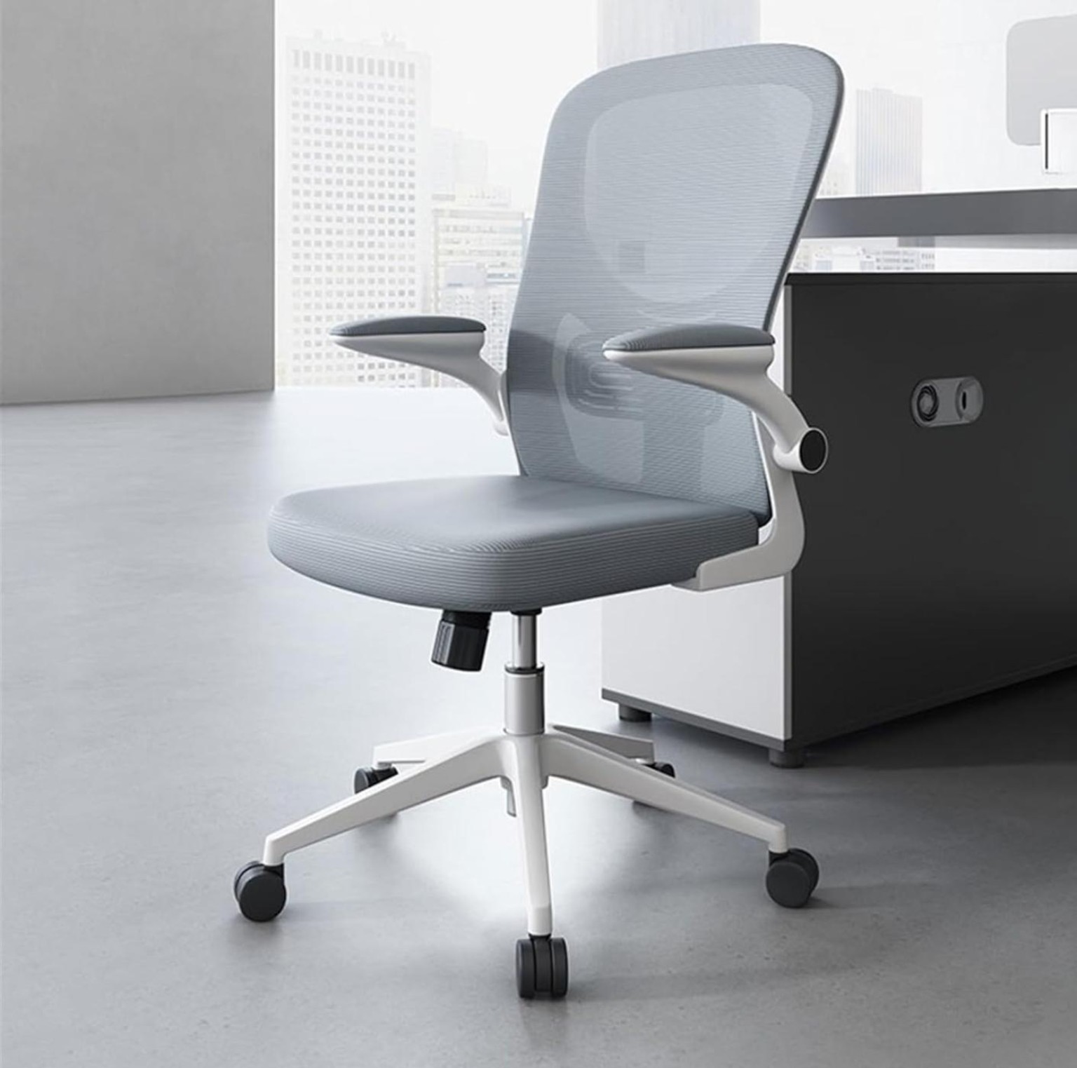 Premium grey ergonomic mesh office chair with adjustable armrests, cushioned seat, swivel base, and caster wheels for home and office use.