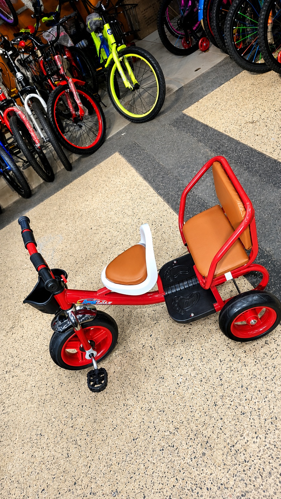 Red kids passenger tricycle with rear seat, front storage basket, comfortable padded seats, and durable three-wheel design for toddlers.