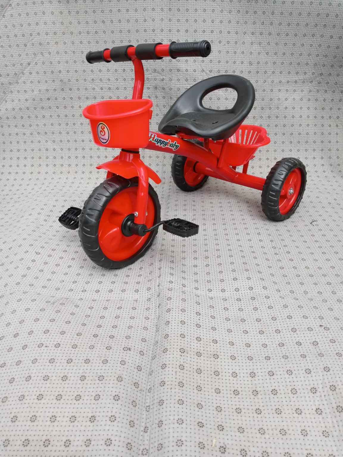 Red kids tricycle with front storage basket, rear basket, comfortable seat, and durable three-wheel design for toddlers.