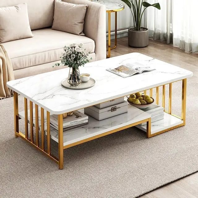 Luxury white marble coffee table with gold metal frame and lower storage shelf in a modern living room.