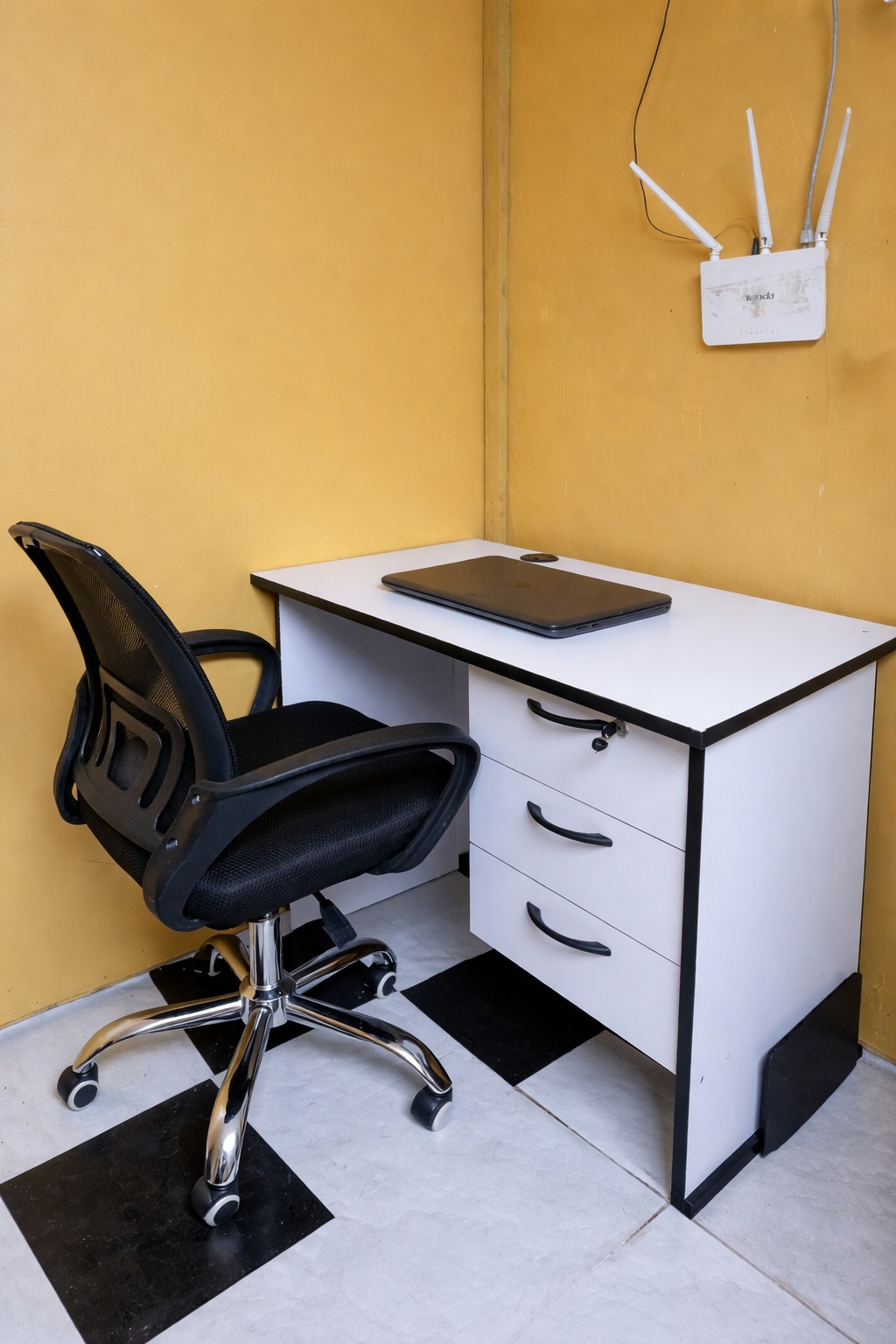 Executive office workstation set with a 1-meter white desk featuring three drawers and a black ergonomic mesh office chair.
