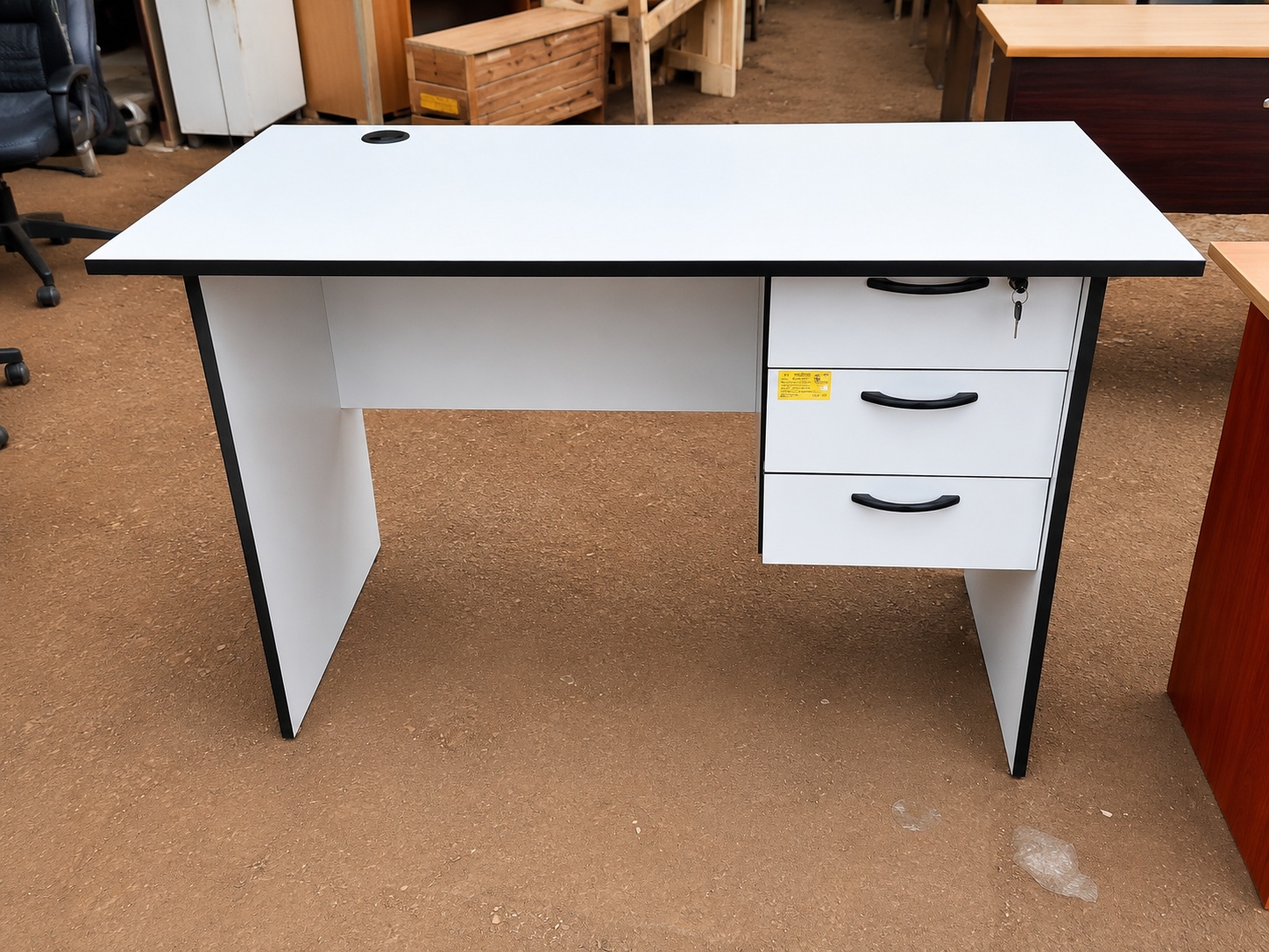 1.2 metre white wooden office desk with three lockable drawers and cable management grommet for office and home workspace.