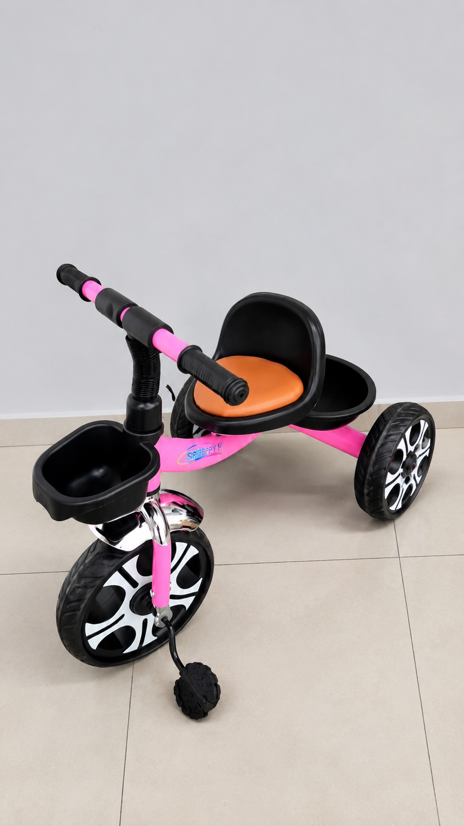 Children's tricycle featuring a front storage basket, rear storage tray, comfortable seat, and stable three-wheel design for young riders.
