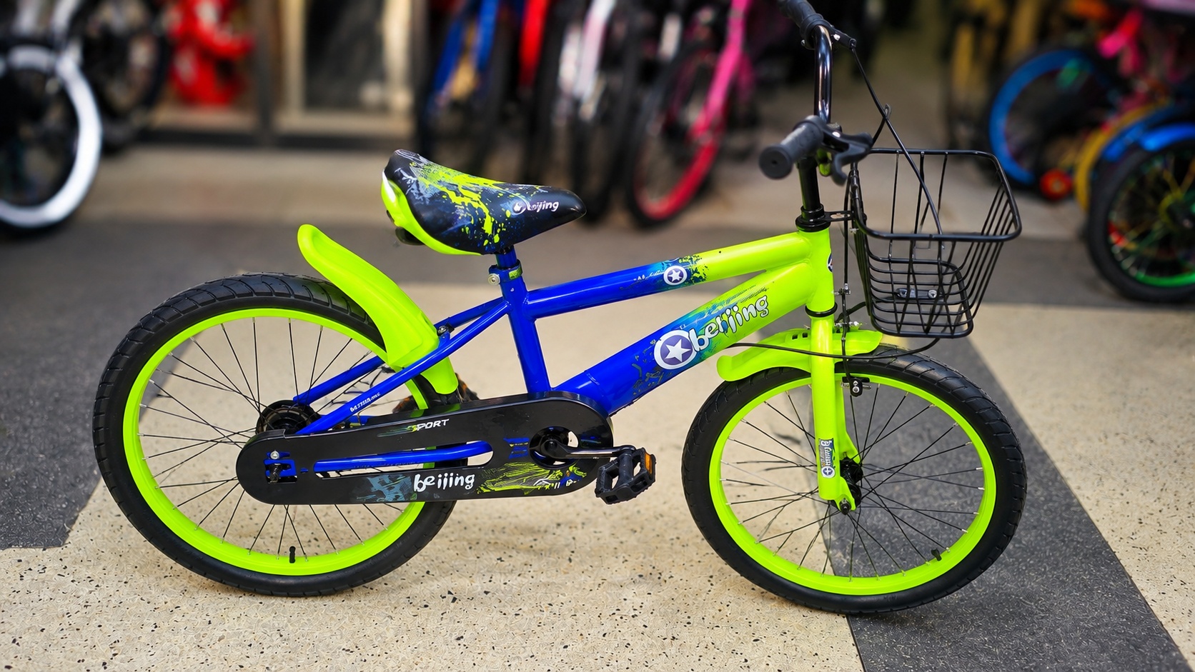 Beijing 20-inch kids bicycle in blue and green with front basket, chain guard, mudguards, and sturdy steel frame for children.