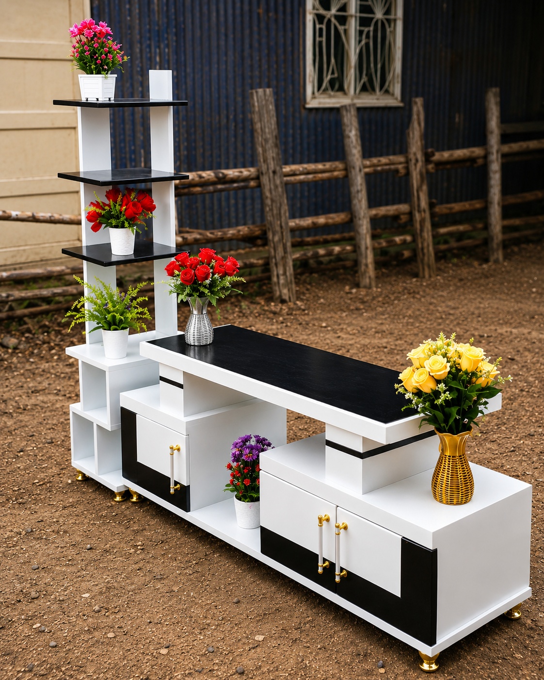 White and black modern TV stand with multiple open shelves, storage cabinets and gold handles
